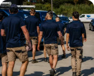 Plumbers walking to their service vans on a Bossley Park job